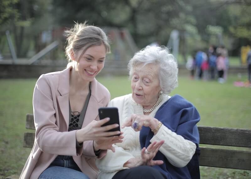 A Legal Guardian Taking Care of an Elderly Woman and Smiling