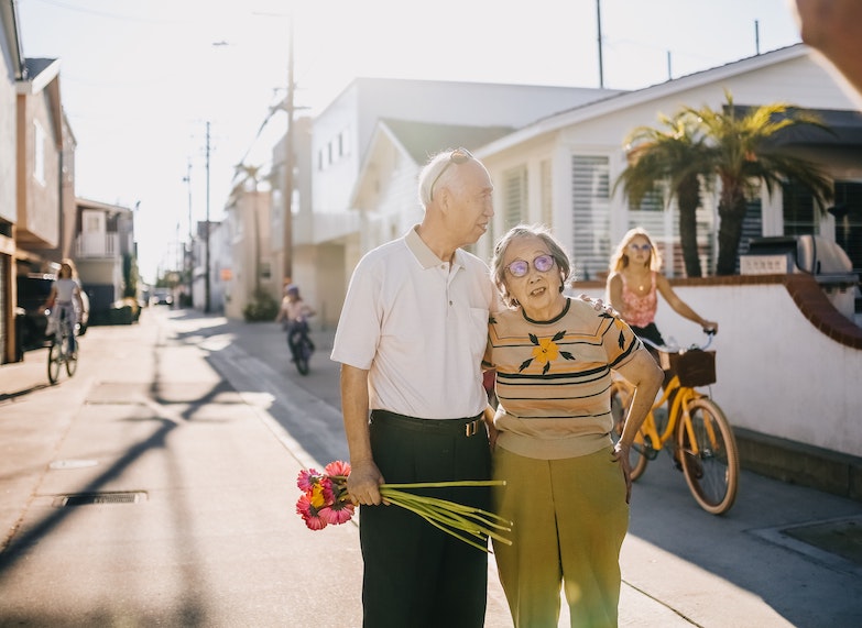 Elder Couple On the Road Walking at Sunset