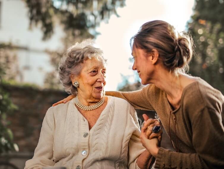 Elderly Lady and Her Legal Guardian Sitting on a Bench in the Park