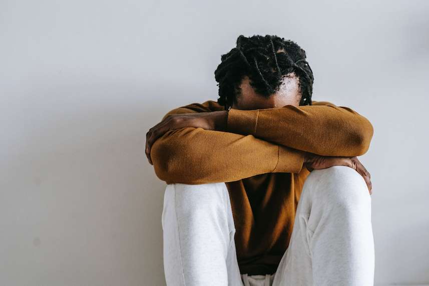 Stages of Grief with Man Sitting Holding his Head Down